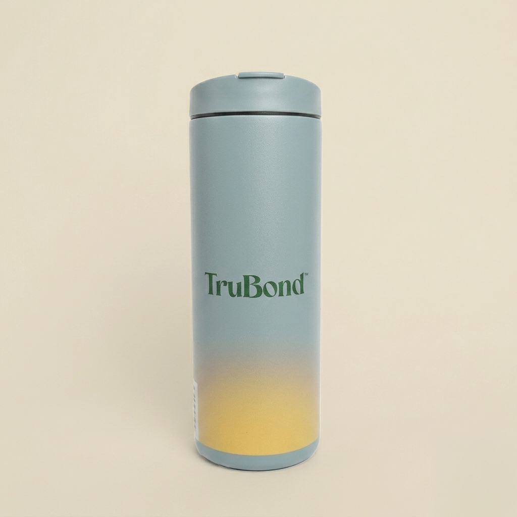 Miir Flip Traveler Gradient-colored thermos with 'TruBond' branding on a beige background